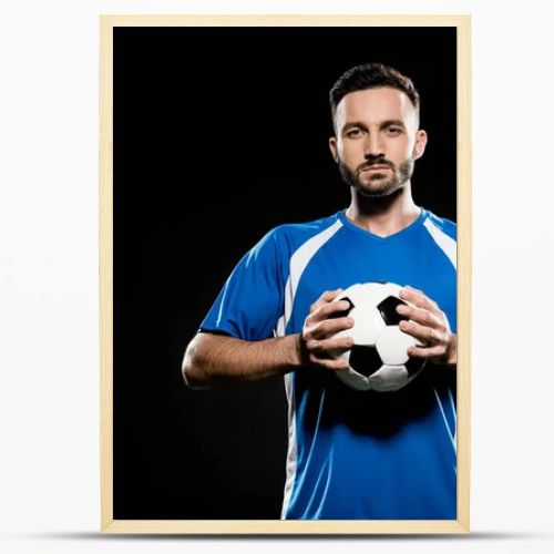 football player holding ball in hands isolated on black