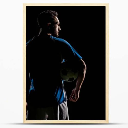 silhouette of muscular sportsman holding ball isolated on black