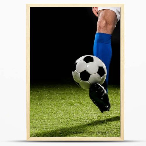 cropped view of man playing with ball on grass isolated on black