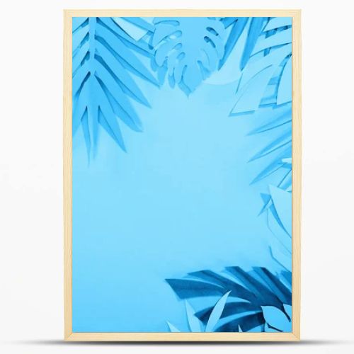 frame of paper leaves on blue minimalistic background with copy space