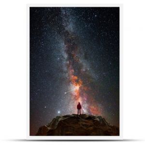 Man on top of a mountain observing the universe