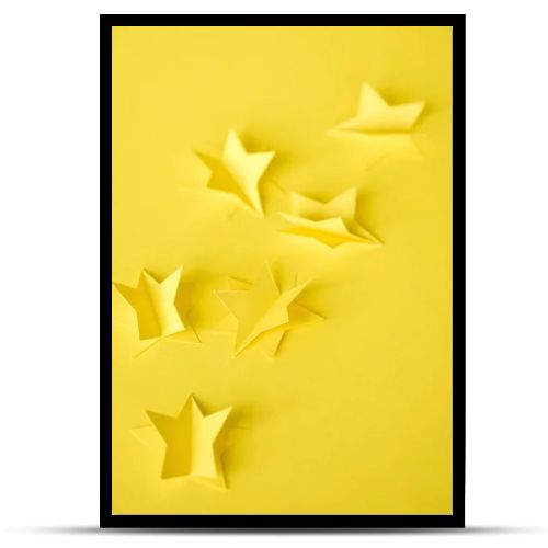 selective focus of paper stars on yellow 