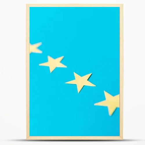 selective focus of yellow stars isolated on blue with copy space