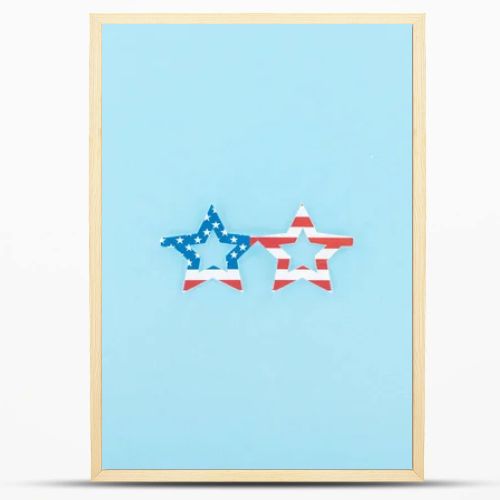 top view of paper cut decorative glasses made of american flag on blue background 