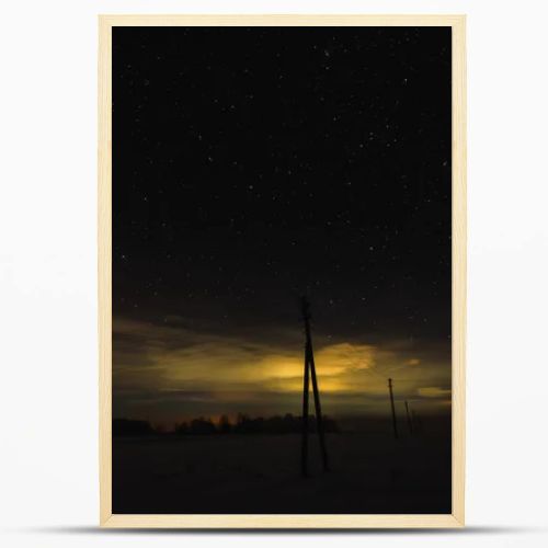 dark sky with yellow illumination in carpathian mountains at night