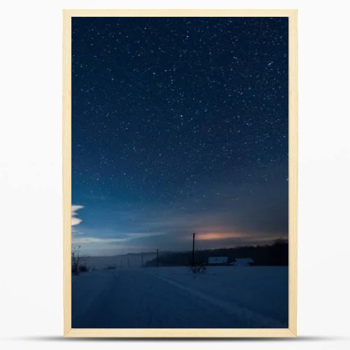 starry dark sky and road in carpathian mountains at night in winter