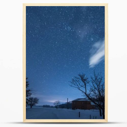 starry dark sky and house in carpathian mountains at night in winter