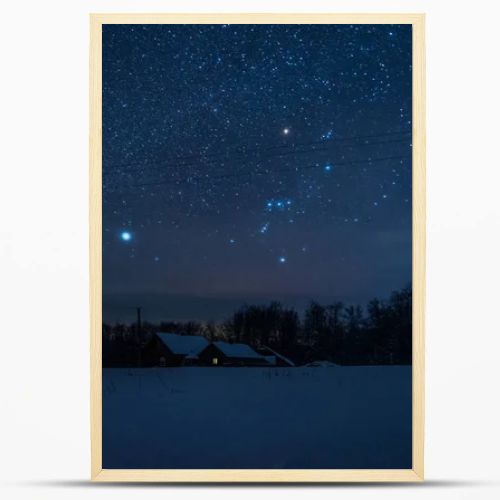 starry dark sky and house in carpathian mountains at night in winter