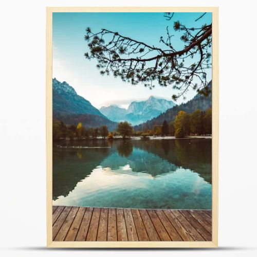 Jasna lake with beautiful reflections of the mountains and wooden pier. Triglav National Park, Slovenia