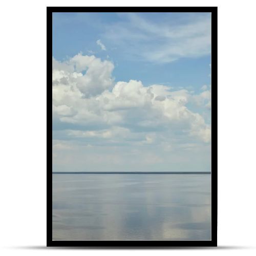 Peaceful landscape with river and white clouds on blue sky