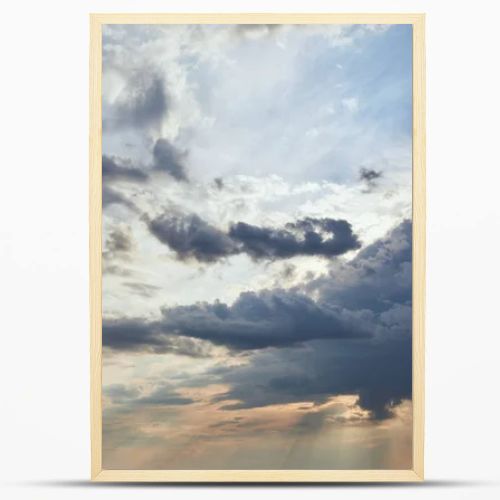 dark clouds and sun rays on blue sky background