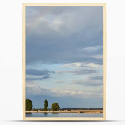 landscape of blue sunlight sky, rainbow, river and coast with trees