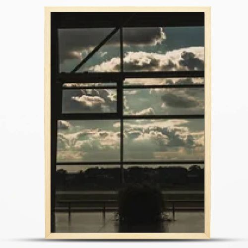 Panoramic orientation of windows in airport waiting hall with cloudy sky at background in Copenhagen, Denmark 