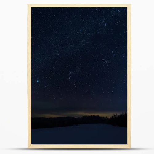 starry dark sky in carpathian mountains at night in winter