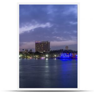 Panoramic view of Cairo city center at twilight, the Kasr El Nile Bridge and the island of Zamalek with its colorful boats on the Nile river.