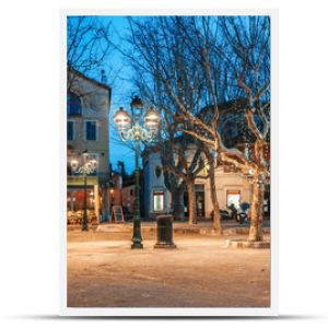 Beautiful night cityscape, tree illumination, lights and benches, central square Saint-Tropez, Provence, France