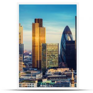 London, United Kingdom - The bank district of central London with famous skyscrapers in golden shine and other landmarks at sunset with blue sky