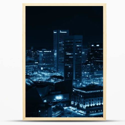 Baltimore inner harbor district rooftop view at night with urban buildings.