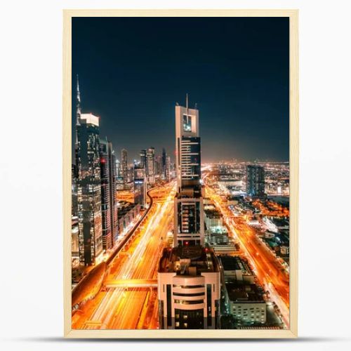 Night view of the spectacular landscape of Dubai with high-rises and skyscrapers at the Sheikh Zayed highway. Global travel destinations and real estate concept