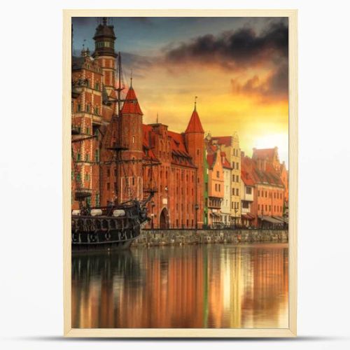 Beautiful old town with historical port crane in Gdansk over Motlawa river at sunset, Poland.