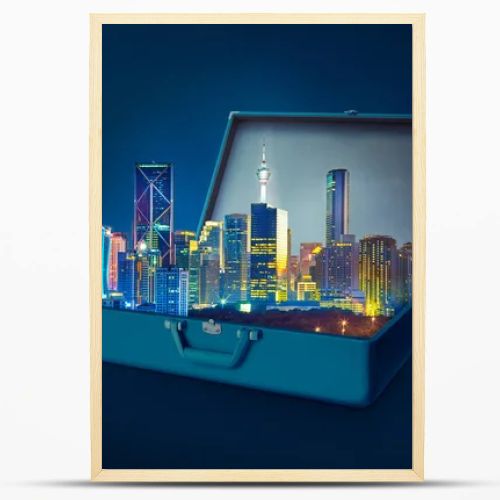 Night scene modern city skyscrapers in an open retro vintage suitcase isolated on blue background 