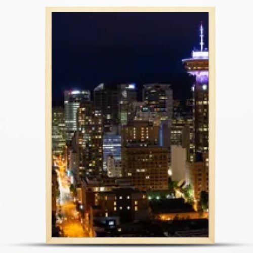 Beautiful panoramic view of the modern cityscape from an aerial perspective at night. Taken in Downtown Vancouver, BC, Canada.