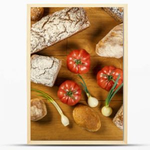 Chleby, pomidory i cebulki - kompozycja na drewnianym stole