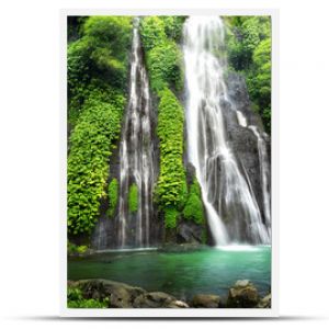 Jungle waterfall cascade in tropical rainforest with rock and turquoise blue pond. Its name Banyumala because its twin waterfall in mountain slope