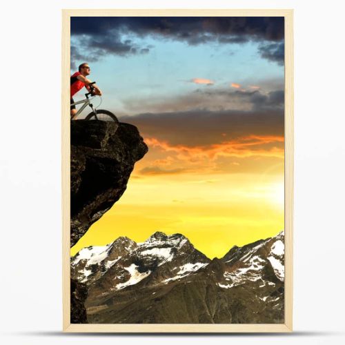 Cyclist on bike at sunset in Pennine Alps