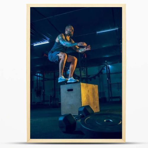 Young healthy man athlete doing exercise in the gym