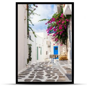 Słynna wąska uliczka starego miasta z białymi domami i kwiatem Bougainvillea wyspa Mykonos Grecja