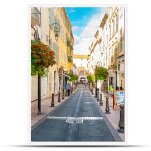 A picturesque street through the old town center of Antibes, France, in the Cote d'Azur, French Riviera region along the Mediterranean Sea.