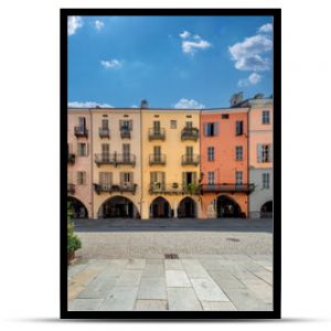 Cuneo, Piedmont, Italy - August 16, 2023: Cityscape on Via Roma, main cobblestone pedestrian street with colorful old buildings and with arcade in historic center