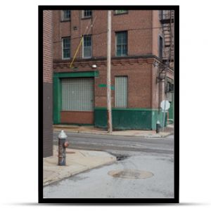 Vintage street scene with abandoned red brick warehouses in a depressed industrial area