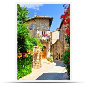 Flower filled medieval street in the beautiful old town of Assisi, Italy