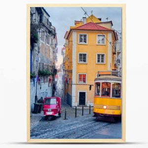 Old tram and tuk-tuk on a street in Lisbon.