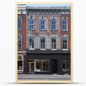 facade of old brick buildings with stores at street level and apartments above