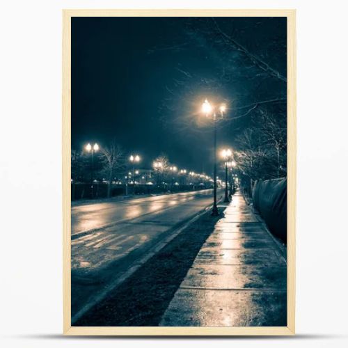 Empty dark and wet urban city street road after rain at night