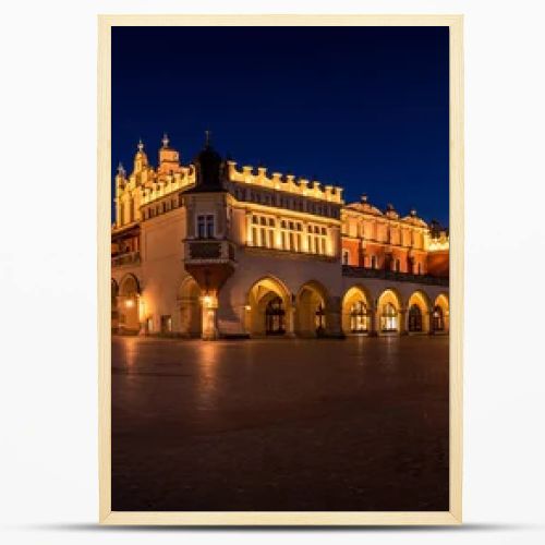Cloth Hall Sukiennice building and main square of the old town illuminated at night on main square of Cracow. Poland  Panoramic view