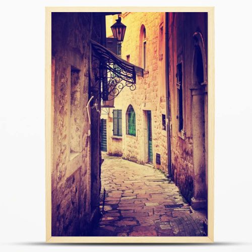 narrow street among old brick buildings in vintage colors