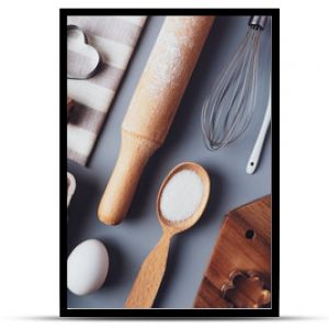 Flat layout composition, baking ingredients and kitchen utensils on a gray background. Culinary trendy background. The concept of making homemade desserts for the holiday