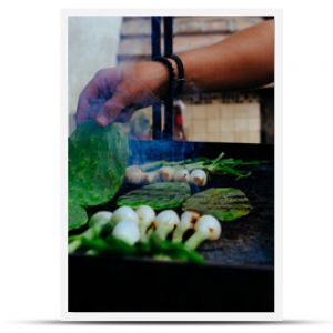 Man grilling fresh vegetables on barbecue in backyard