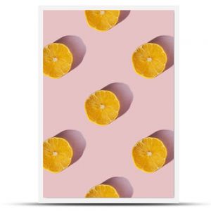 Uniform pattern of dried lemon slices with shadow on a pink background. Flat lay