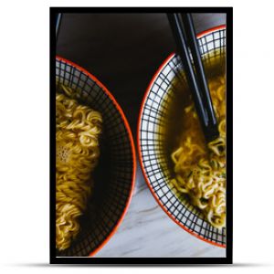 Instant pasta, Japanese and Chinese noodles. Ramen type soup in a plate with chopsticks, junk fast food. Quick-cooking pasta.