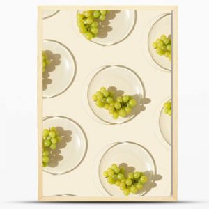 Food pattern from bunch white grapes on glass plate with shadows at sunlight, minimal style summer fruit on beige colored fon, green berries of grape, top view, trend flat lay, food