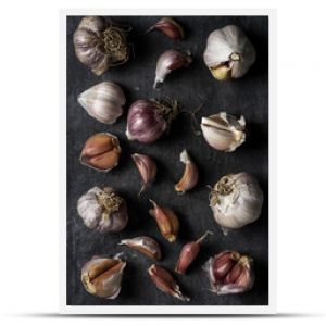 Fresh garlic bulbs and cloves grouped on black background