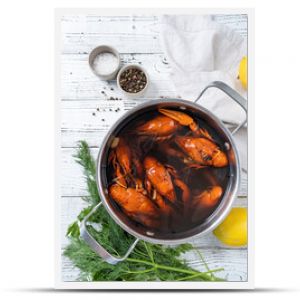 cooked crawfish in saucepan with lemons and spices on wooden background