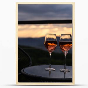 Two glasses of wine standing with a beautiful scenic mountain view. Mountain resort, enjoy moment