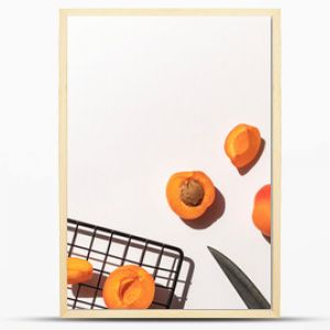 Organic ripe apricots under sun shadows on the white table top view