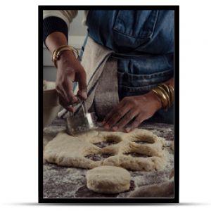 Biscuit cutter being used on dough